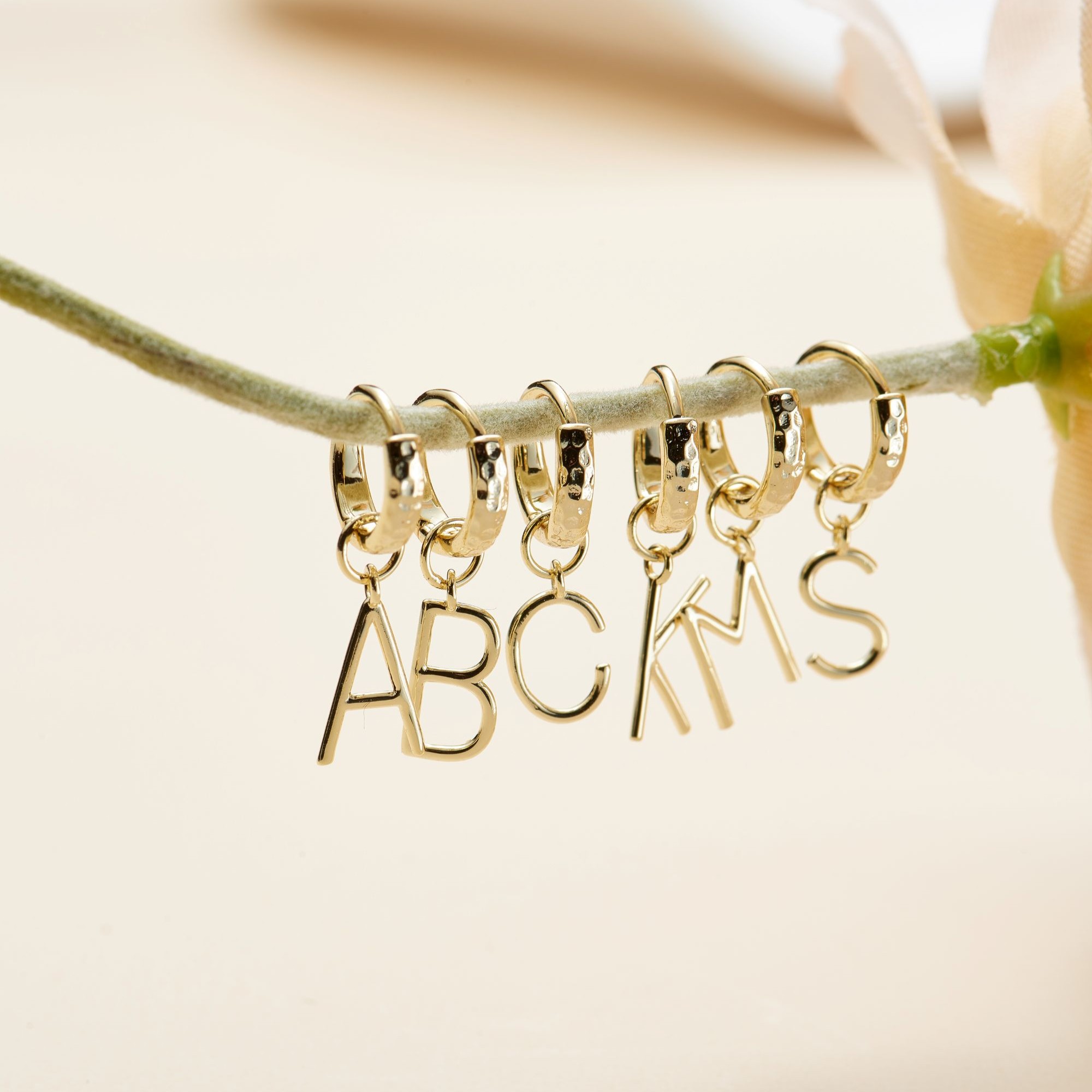 Picture of gold mini letter initial huggie hoop earrings - J