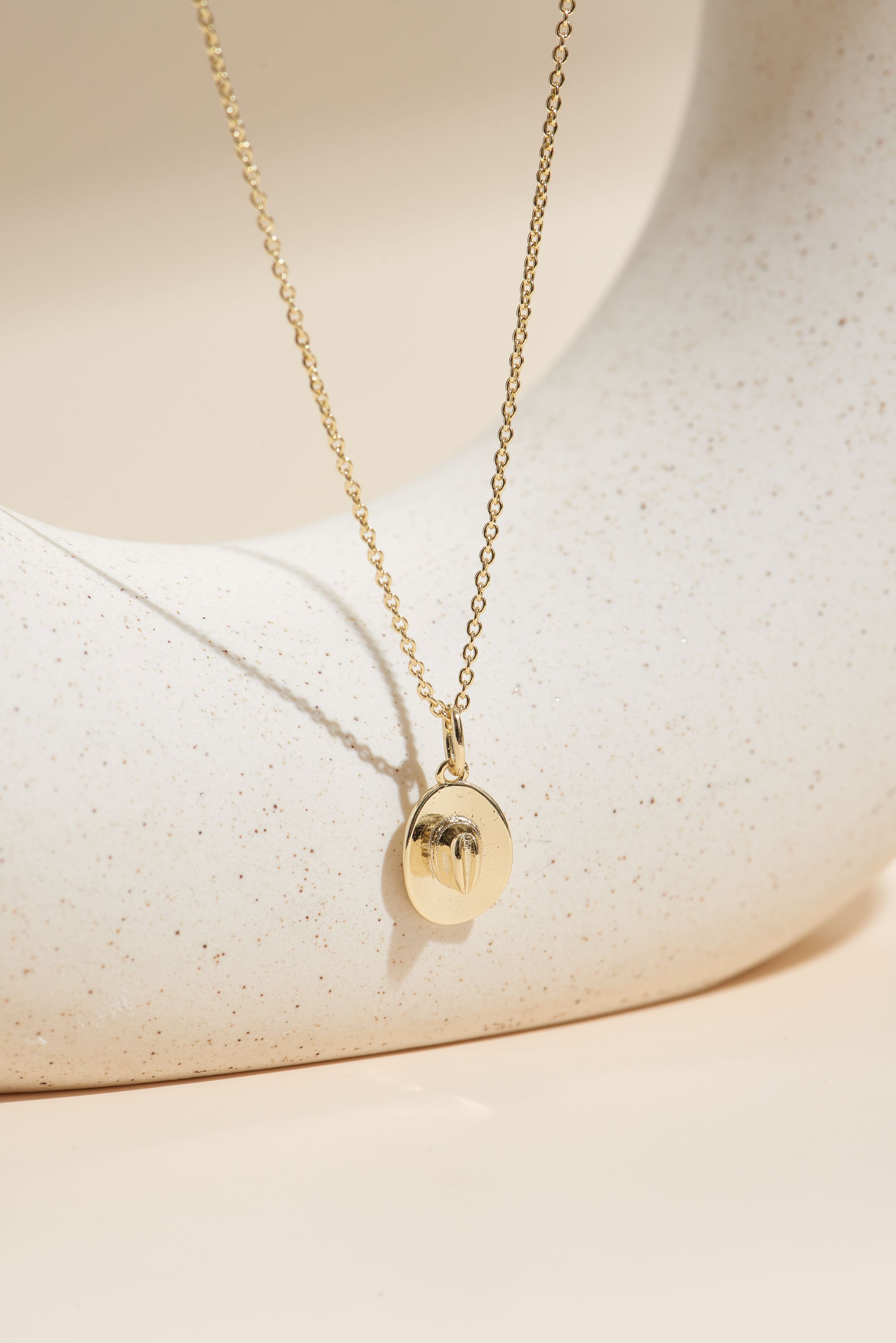 Picture of gold wish and wonder cowboy hat necklace