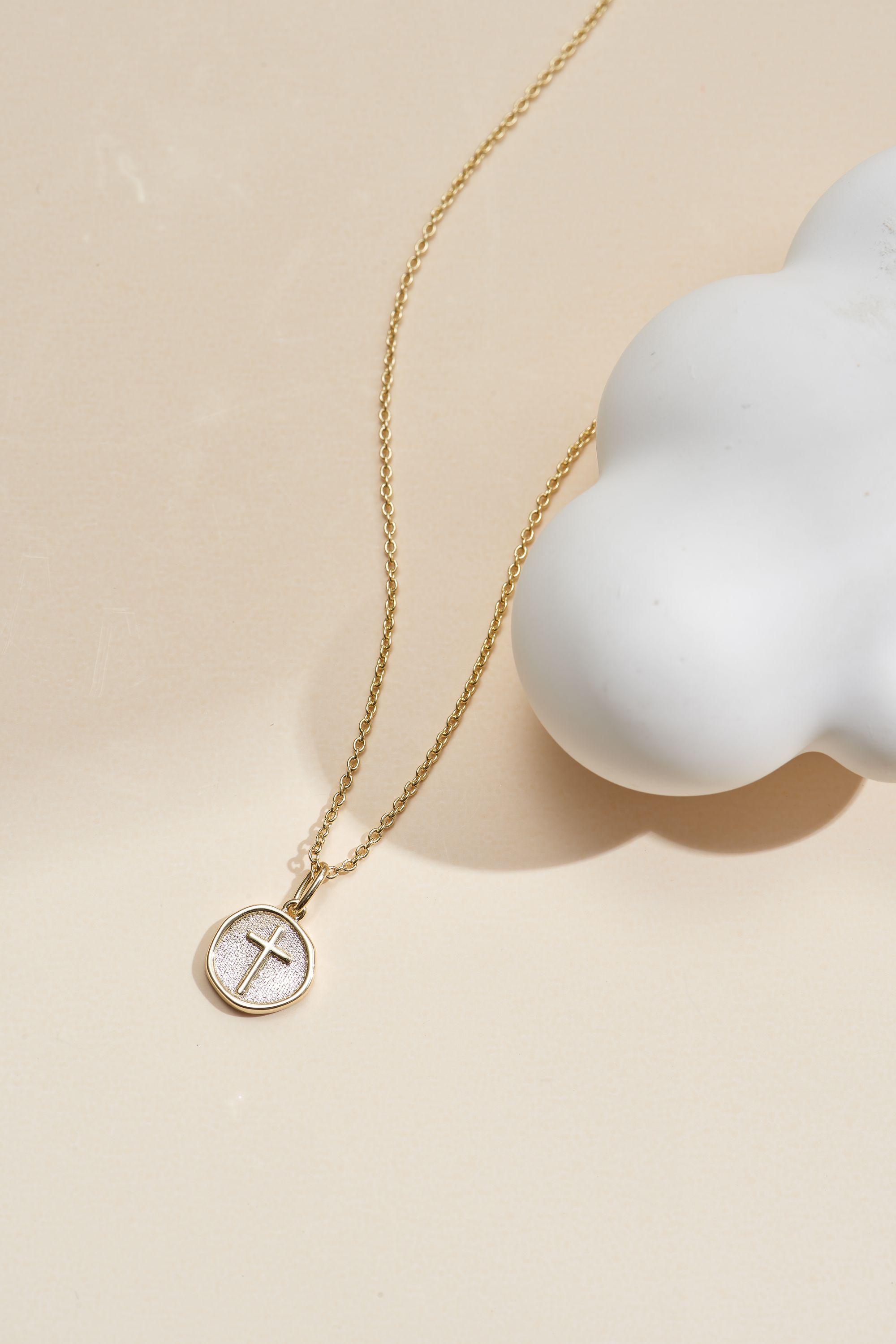 Picture of gold wish and wonder coin cross necklace