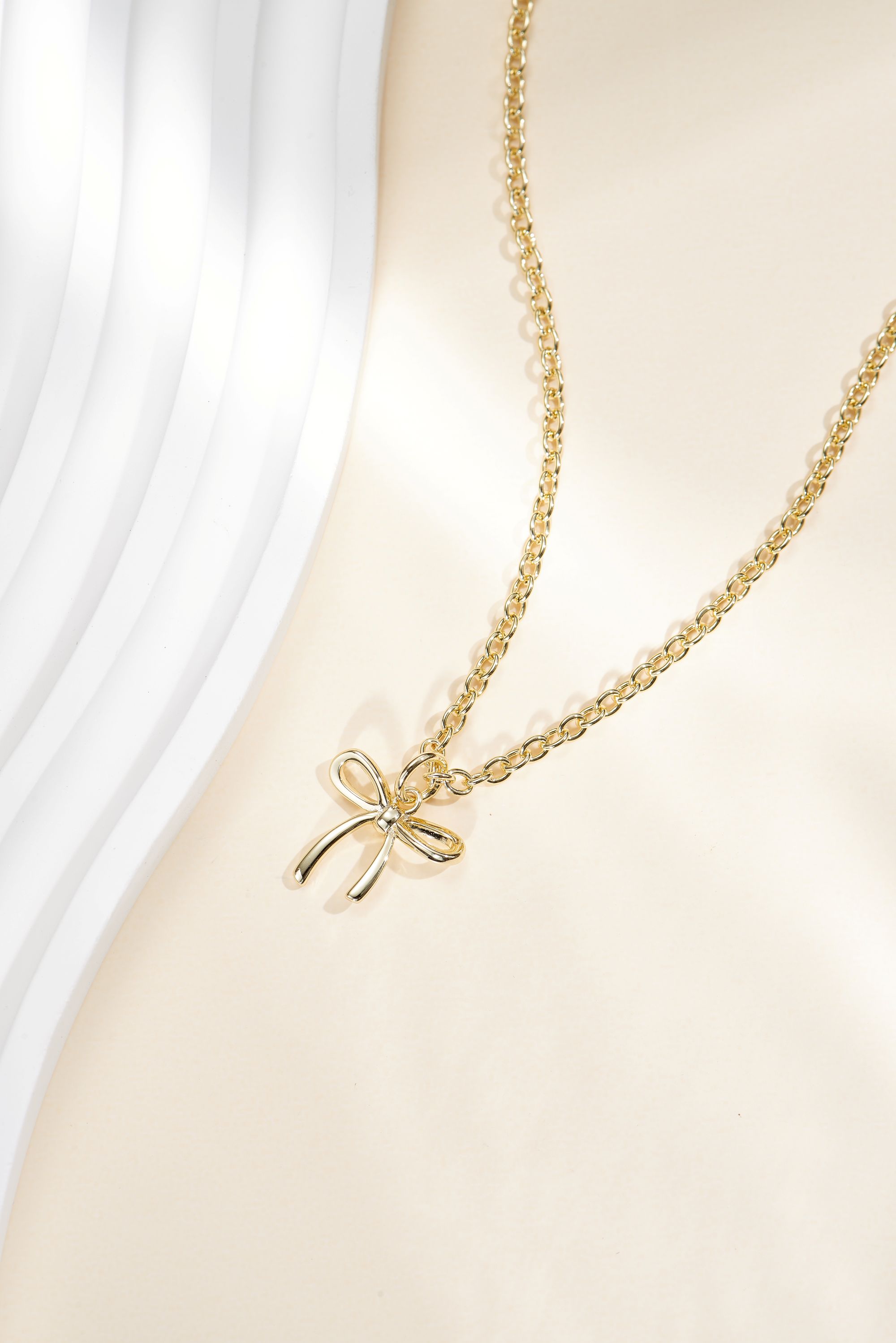 Picture of gold wish and wonder bow necklace